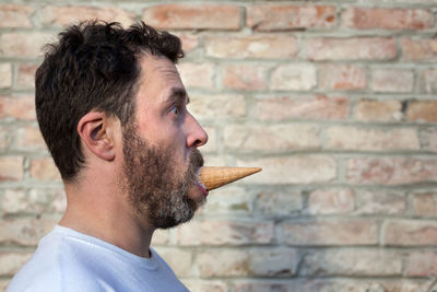 Side view of man eating ice cream
