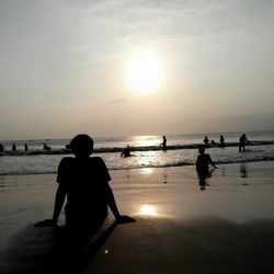 People on beach at sunset