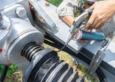 Cropped hands of man holding equipment