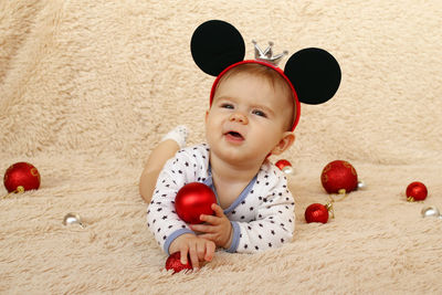 High angle view of girl by decoration on carpet