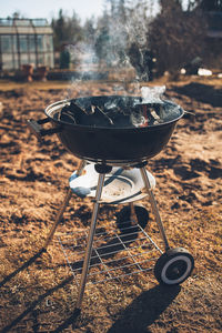 Charcoal is smoked on a barbecue grill.