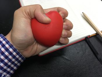 Close-up of hand holding red wine