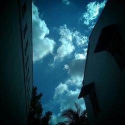 Low angle view of building against cloudy sky