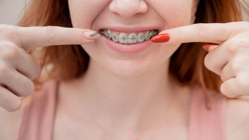 Midsection of woman with dentures