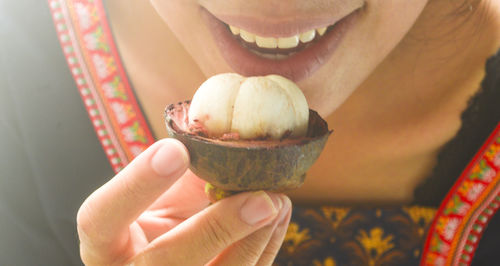 Midsection of woman holding ice cream