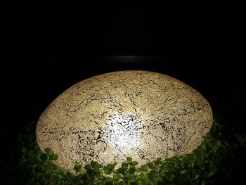 Close-up of illuminated lamp in darkroom