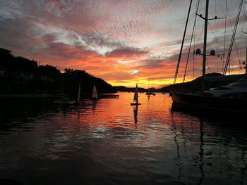 View of boats in sea at sunset