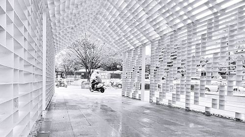 Man on street amidst buildings in city