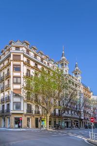 Low angle view of historic building against clear blue sky