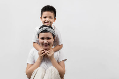 Portrait of smiling boy against white background