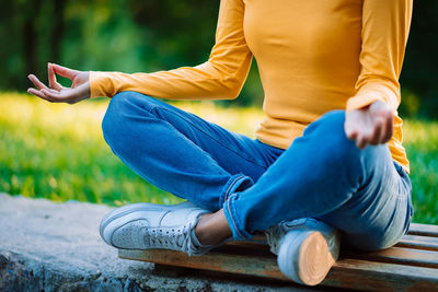 Low section of man sitting outdoors