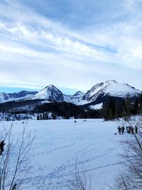 Scenic view of snow covered mountains against sky