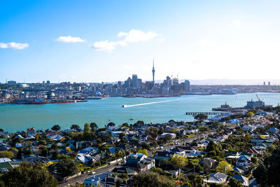 Buildings in city against cloudy sky
