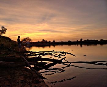 Scenic view of lake against orange sky