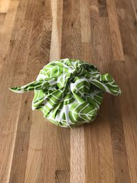 High angle view of object tied in green fabric on table