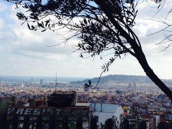 Cityscape against cloudy sky