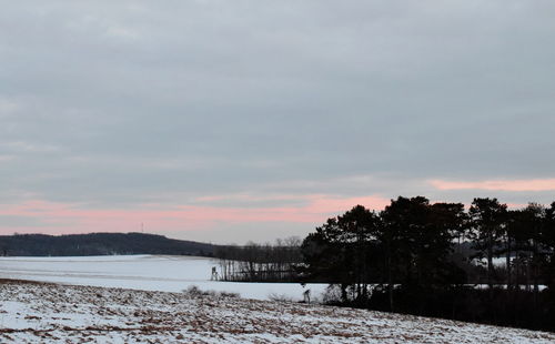 Scenic view of lake against sky during winter