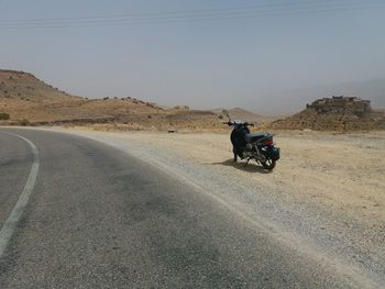 People riding motorcycle on road