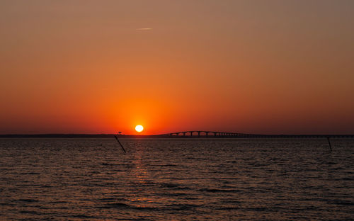 Scenic view of sea against orange sky