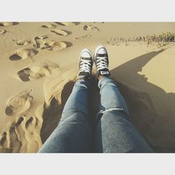 Low section of woman standing on tiled floor