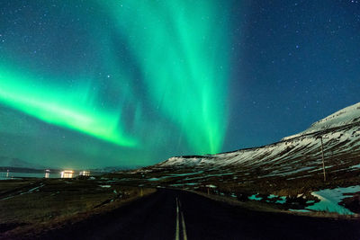 Road against sky at night during winter