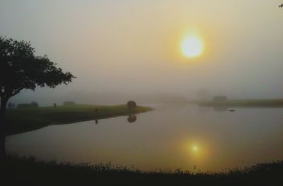 Scenic view of lake at sunset