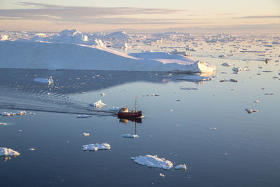 Aerial view of frozen sea against sky during winter