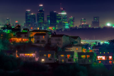High angle view of illuminated buildings against sky at night