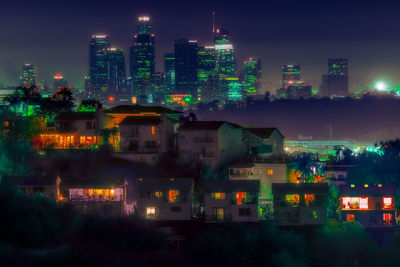 High angle view of illuminated buildings against sky at night