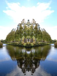 View of trees by lake against sky