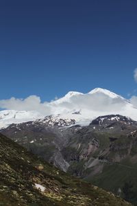 Scenic view of mountains against clear blue sky