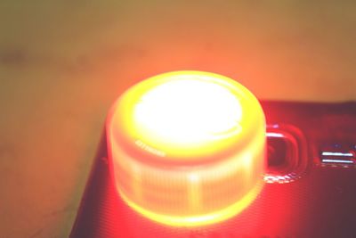 Close-up of illuminated lamp on table