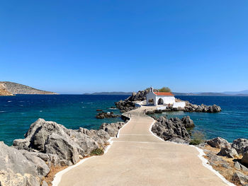 Scenic view of sea against clear blue sky