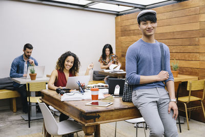 Portrait of young couple standing on table