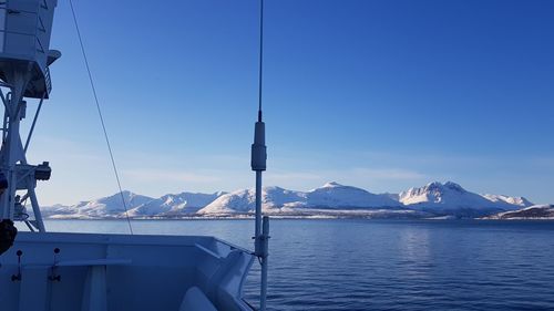 Scenic view of lake by snowcapped mountains against sky