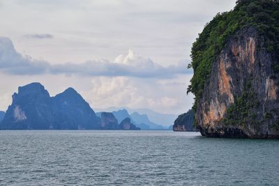 Scenic view of sea and mountains against sky