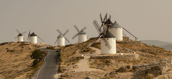 Traditional windmill on landscape against clear sky