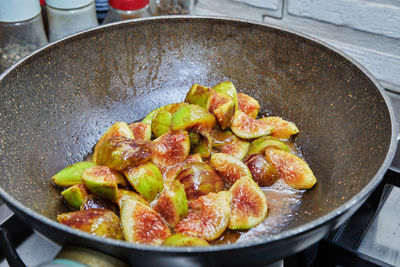 Figs are fried in frying pan on gas stove, for cooking according to recipe from the internet