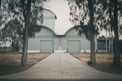 Empty park by building against sky