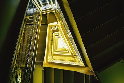 Directly below view of yellow metallic staircase in building