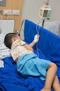 Boy lying on bed at hospital