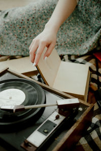 High angle view of woman reading book on table