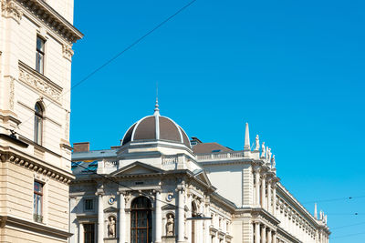 Low angle view of government building in city against clear sky