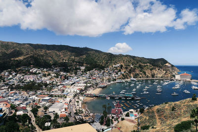 High angle view of townscape by sea against sky