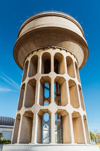 Low angle view of historic building against blue sky