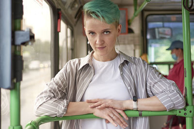 Portrait of young woman sitting in city