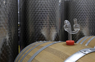 Wine production - a wooden cask with red wine and a valve to let out co2