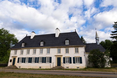 Low angle view of building against cloudy sky