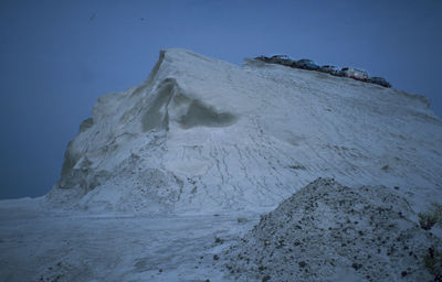 Scenic view of snowcapped mountains against clear sky during winter