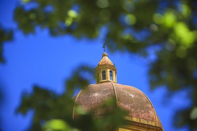 Low angle view of bell tower against sky